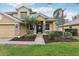 Two-story house with a charming facade and manicured lawn at 1395 Legendary Blvd, Clermont, FL 34711