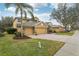 Two-story house with a three-car garage and landscaped yard at 1395 Legendary Blvd, Clermont, FL 34711