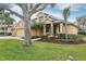 Two-story house with a three-car garage and landscaped yard at 1395 Legendary Blvd, Clermont, FL 34711