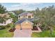 Stunning two-story house with a brick paved driveway and well manicured lawn at 1395 Legendary Blvd, Clermont, FL 34711