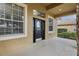 Covered porch with black door and sidelights at 1395 Legendary Blvd, Clermont, FL 34711