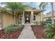 Elegant entryway with a black door and stone accents at 1395 Legendary Blvd, Clermont, FL 34711