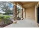 Inviting front porch with stone columns and a view of the landscaped yard at 1395 Legendary Blvd, Clermont, FL 34711