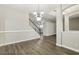 Bright and airy living room with hardwood floors and a staircase at 1395 Legendary Blvd, Clermont, FL 34711