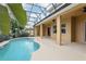 Inviting pool area with covered patio, lush landscaping, and ample space for relaxation at 1395 Legendary Blvd, Clermont, FL 34711