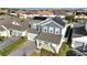 Aerial view showcasing a house with solar panels and a neighborhood backdrop at 14789 Milfoil Ave, Orlando, FL 32827