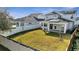 Large backyard with green grass, white fence, a covered patio, and space for outdoor activities at 14789 Milfoil Ave, Orlando, FL 32827