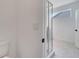 Bright bathroom featuring a glass-enclosed shower, white walls, and light tile flooring at 14789 Milfoil Ave, Orlando, FL 32827