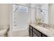 Bright bathroom featuring a shower-tub combination with white tile and a granite vanity at 14789 Milfoil Ave, Orlando, FL 32827