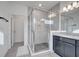 Elegant bathroom featuring a walk-in shower and dark cabinetry at 14789 Milfoil Ave, Orlando, FL 32827