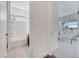 Bathroom with a shower and a small office space with a desk and chair beyond the door at 14789 Milfoil Ave, Orlando, FL 32827