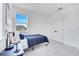 Bright bedroom with large window, soft carpet, and bed with deep blue bedding at 14789 Milfoil Ave, Orlando, FL 32827