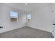 Well-lit bedroom featuring neutral walls and carpet at 14789 Milfoil Ave, Orlando, FL 32827