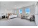 Spacious bedroom bathed in natural light with a large bed and sitting area near the windows at 14789 Milfoil Ave, Orlando, FL 32827