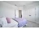 Bedroom featuring plush carpet, a bed with lilac blanket, and double door closet at 14789 Milfoil Ave, Orlando, FL 32827