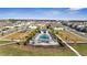 Aerial view of a community pool surrounded by lounge chairs, palm trees and lush green space at 14789 Milfoil Ave, Orlando, FL 32827