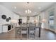 Bright dining room and kitchen featuring a modern chandelier, white cabinets, and stainless steel appliances at 14789 Milfoil Ave, Orlando, FL 32827