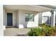 Entrance featuring a blue front door and an outdoor seating area with decorative landscaping around the entrance at 14789 Milfoil Ave, Orlando, FL 32827