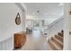 Inviting entryway with a stylish wooden cabinet, staircase, and open view into the dining and living areas at 14789 Milfoil Ave, Orlando, FL 32827