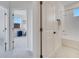 Hallway showcasing access to a bedroom and bathroom with neutral-toned walls and trim at 14789 Milfoil Ave, Orlando, FL 32827