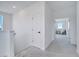 Upstairs hallway featuring neutral carpet and leads to a bedroom with a window at 14789 Milfoil Ave, Orlando, FL 32827