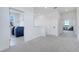 Hallway with view of laundry room on the left and sitting area on the right at 14789 Milfoil Ave, Orlando, FL 32827