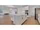 White kitchen island with ample storage and seating at 14789 Milfoil Ave, Orlando, FL 32827