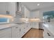 Modern kitchen with white cabinets, quartz countertops and stainless steel appliances at 14789 Milfoil Ave, Orlando, FL 32827