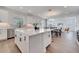 Open-concept kitchen and dining area featuring a large island, stainless steel appliances, and stylish finishes at 14789 Milfoil Ave, Orlando, FL 32827