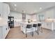 Stylish kitchen featuring white cabinets, stainless steel appliances, and a large center island with bar stool seating at 14789 Milfoil Ave, Orlando, FL 32827