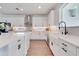 Well-appointed kitchen with white cabinets, stainless steel appliances, quartz countertops, and stylish backsplash at 14789 Milfoil Ave, Orlando, FL 32827