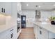 Modern kitchen with white cabinets, stainless steel appliances, and quartz countertops at 14789 Milfoil Ave, Orlando, FL 32827