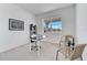 Well-lit home office space with a neat desk setup and relaxing, woven chairs, bathed in natural light at 14789 Milfoil Ave, Orlando, FL 32827