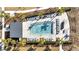 Aerial view of a modern community pool with ample seating and well-manicured landscaping at 14789 Milfoil Ave, Orlando, FL 32827