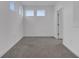 Bright bedroom with carpet and three windows at 14789 Milfoil Ave, Orlando, FL 32827