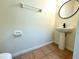 Simple, updated half bathroom with pedestal sink and tile flooring at 1604 Scarlet Oak Loop # B, Winter Garden, FL 34787