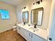 Modern bathroom with double vanity, white cabinets, and black matte fixtures at 1604 Scarlet Oak Loop # B, Winter Garden, FL 34787