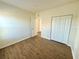 Spacious bedroom with wood-look floors and a large closet at 1604 Scarlet Oak Loop # B, Winter Garden, FL 34787