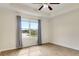 Bedroom featuring wood-look floors, ceiling fan, and window overlooking the backyard at 1604 Scarlet Oak Loop # B, Winter Garden, FL 34787