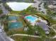 Aerial view of pool, basketball courts, and lake within the residential community at 1604 Scarlet Oak Loop # B, Winter Garden, FL 34787