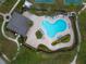 Aerial view of a large community pool with blue lounge chairs, palm trees, and surrounding sidewalks at 1604 Scarlet Oak Loop # B, Winter Garden, FL 34787