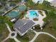 Aerial view of the community pool, basketball courts, and clubhouse surrounded by lush landscaping at 1604 Scarlet Oak Loop # B, Winter Garden, FL 34787