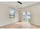 Bright dining room with modern lighting, window, and sliding door to the exterior at 1604 Scarlet Oak Loop # B, Winter Garden, FL 34787