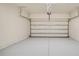 Spacious, clean garage with white walls and sealed concrete flooring at 1604 Scarlet Oak Loop # B, Winter Garden, FL 34787