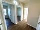 Light hallway with wood-look floors and access to multiple rooms at 1604 Scarlet Oak Loop # B, Winter Garden, FL 34787