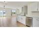 A bright kitchen area showcases stainless appliances and an open floor plan with living area at 1604 Scarlet Oak Loop # B, Winter Garden, FL 34787