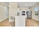 A modern kitchen with white cabinetry, stainless steel appliances, and counter-height seating at 1604 Scarlet Oak Loop # B, Winter Garden, FL 34787