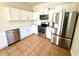 Modern kitchen featuring stainless steel appliances and white cabinetry at 1604 Scarlet Oak Loop # B, Winter Garden, FL 34787