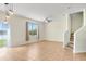 A bright living room features tile floors, a ceiling fan, and a large window with natural light at 1604 Scarlet Oak Loop # B, Winter Garden, FL 34787