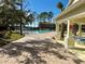 View of the community pool with lounge chairs and tables surrounded by mature trees and green space at 1604 Scarlet Oak Loop # B, Winter Garden, FL 34787